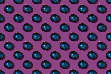 Creative minimal Christmas art. Pattern made with Christmas decorations on bright purple background. Flat lay. Copy space. Minimal composition.