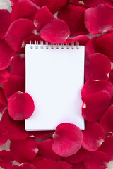 frame of red rose petals with blank notepad. flat lay. top view. mockup. copy space. minimalist style