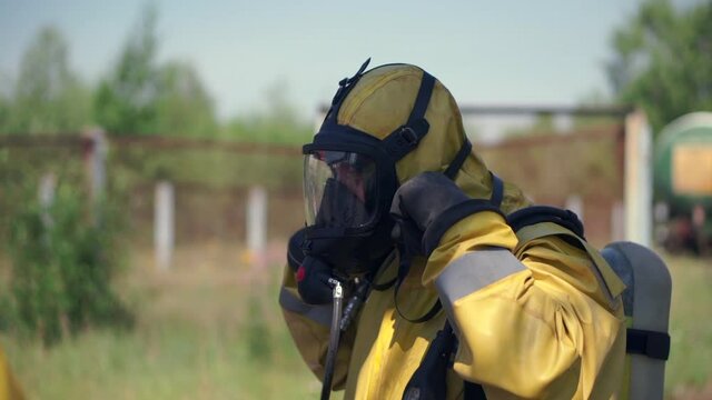 Work in a gas mask. Clip. Working moment in the danger zone in a special suit