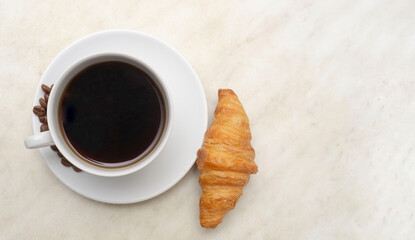 cup of espresso coffee with croissant by morning.