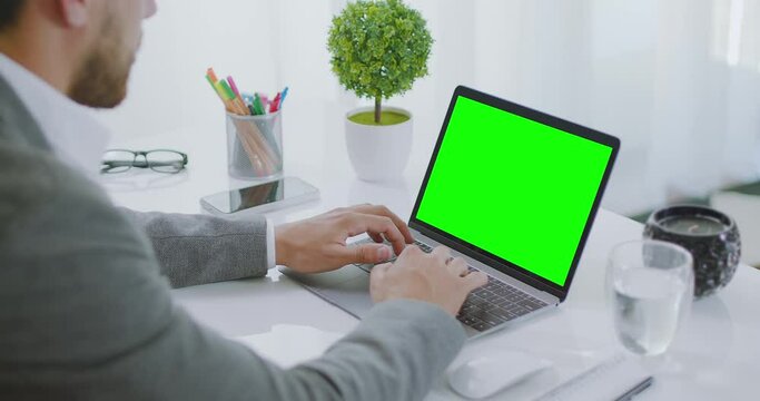  
Sequence of Shots Young Millennial Professional Using Computer at Office. Focused Businessman Thinking and Typing on Laptop. Busy Freelancer Working on Modern Tech Notebook Device. Over the Shoulder