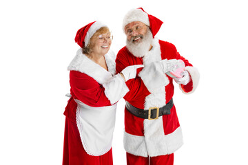 Happy smiling old man in Santa Claus costume and cute woman, missis Claus with gift boxes isolated on white background.