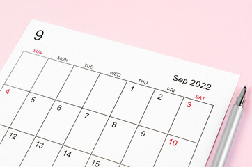 September 2022 calendar sheet with pen on pink