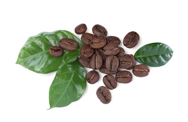 Roasted coffee beans with fresh leaves on white background, top view