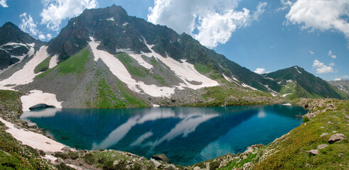 Naklejka na ściany i meble A large, blue mountain lake in summer in high resolution