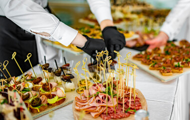 waiter prepare food for a buffet table in a restaurant