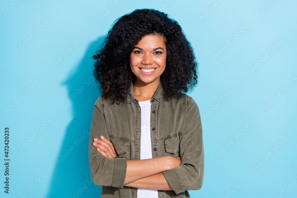 Sticker Photo of young cheerful lovely african girl good mood crossed hands expert isolated over blue color background