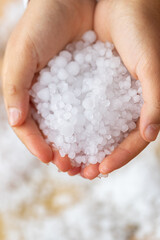 Hail on the hand, hand holding graupel