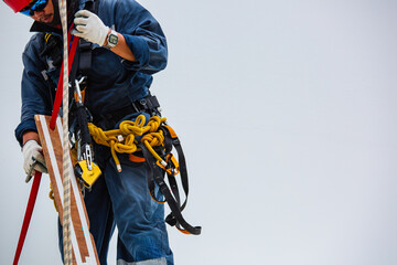 Closeup male worker standing on tank male worker height roof tank knot carabiner rope.