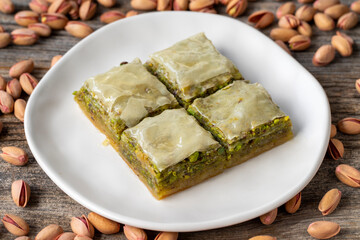 Pistachio baklava on a wooden background. Turkish style pistachio baklava presentation and service. Horizontal view. close up
