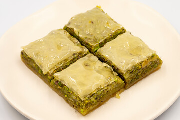Pistachio baklava on a white background. Turkish style pistachio baklava presentation and service. Horizontal view. close up
