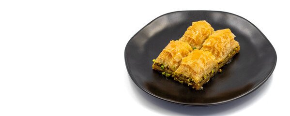 Pistachio baklava isolated on a white background. Turkish style pistachio baklava presentation and service. Empty space for text. Copy space