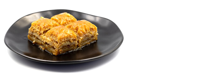 Walnut Baklava on white background. Turkish style walnut baklava presentation and service. Empty space for text. Copy space