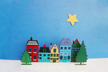 Colorful Row Home Cutouts with White Ground and Yellow Star on Dark Blue Sky