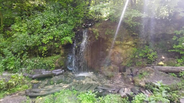Russia, Pushchino on the Oka River. A beautiful waterfall near Moscow in the summer. Aerial Video of Eco trail and green vegetation.