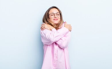 pretty caucasian woman feeling in love, smiling, cuddling and hugging self, staying single, being...