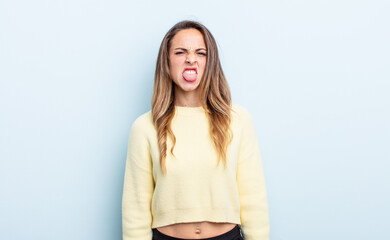 pretty caucasian woman feeling disgusted and irritated, sticking tongue out, disliking something...