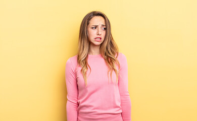 pretty caucasian woman looking worried, stressed, anxious and scared, panicking and clenching teeth