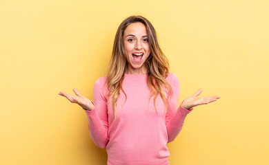 pretty caucasian woman feeling happy, excited, surprised or shocked, smiling and astonished at...