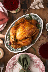 baked chicken in Christmas dekor with candles and serving