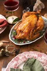 baked chicken in Christmas dekor with candles and serving
