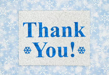 Thank You greeting on silver greeting card on blue snowflakes