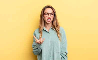 pretty caucasian woman looking angry, annoyed and frustrated screaming wtf or what’s wrong with...