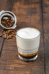 Cortado coffee with coffee beans next to it. Traditional coffee in Spain.