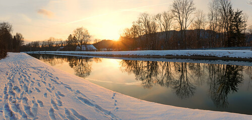 romantic sunset at Isar river channel, winter scenery at Schaftlarn, bavaria