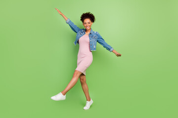 Fototapeta na wymiar Full body photo of nice young lady dance wear dress shirt sneakers isolated on green background