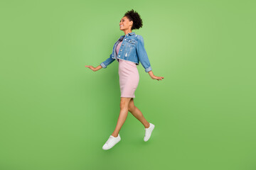 Fototapeta na wymiar Full size profile photo of funky millennial lady jump wear dress shirt sneakers isolated on green background