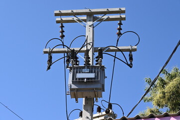Outdoor AC high voltage transformers to supply electricity, installed on cement poles, transfer...