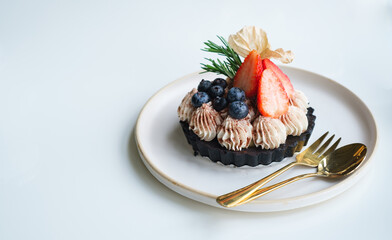 banoffee mix berry pie, Strawberry and blueberry topping on canoffee cake. sweet dessert food menu on white table, with copy space for text.