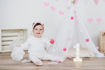 Cute girl with candle on birthday at home