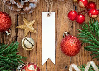 Blank gift label with Christmas decorations around top view, Mockup