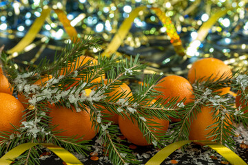 Obraz premium New Year's decoration - tangerines, spruce branches and serpentine