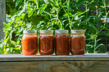 Freshly canned salsa in a country setting