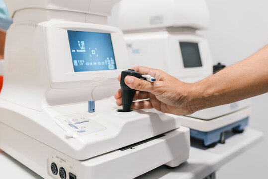 Crop doctor man conducting autorefractometry on modern medical equipment