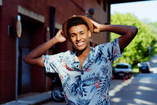 Trendy young black man portrait posing in the street