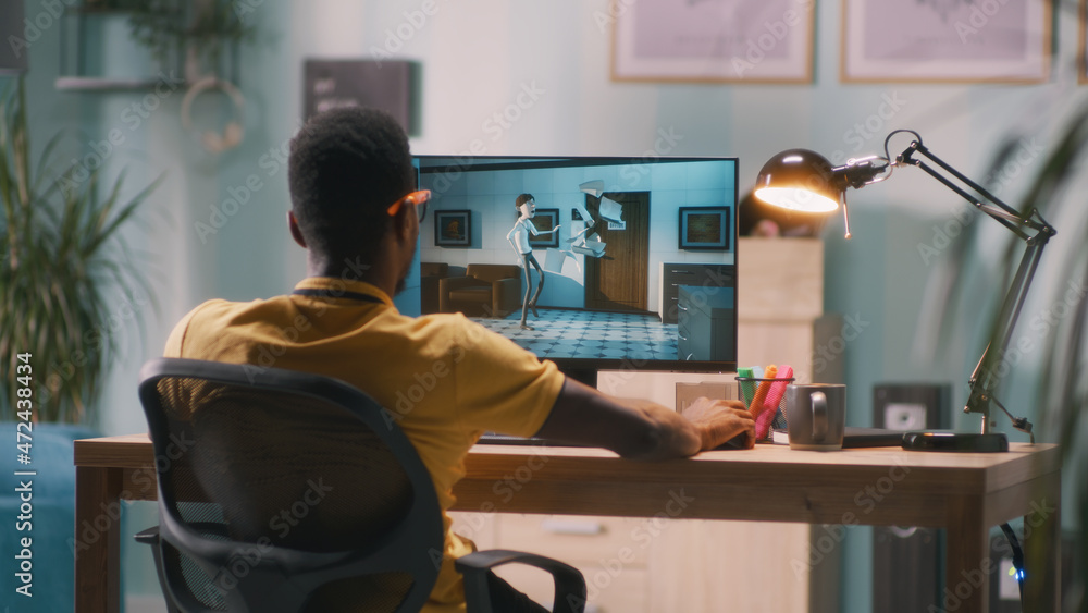 Poster black man in glasses rendering 3d cartoon on computer while working in home office
