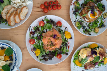 Danish open sandwich Smorrebrod with salmon on rye bread with vegetables and herbs
