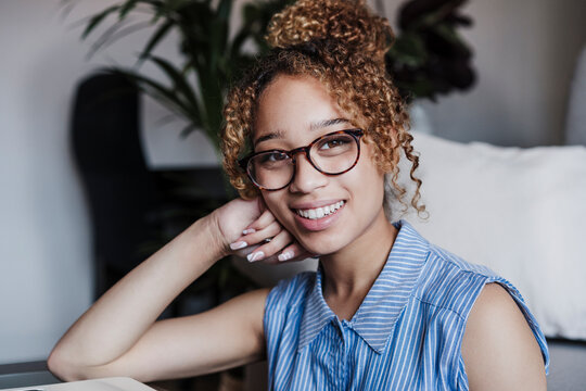 Beautiful smiling woman sitting at home