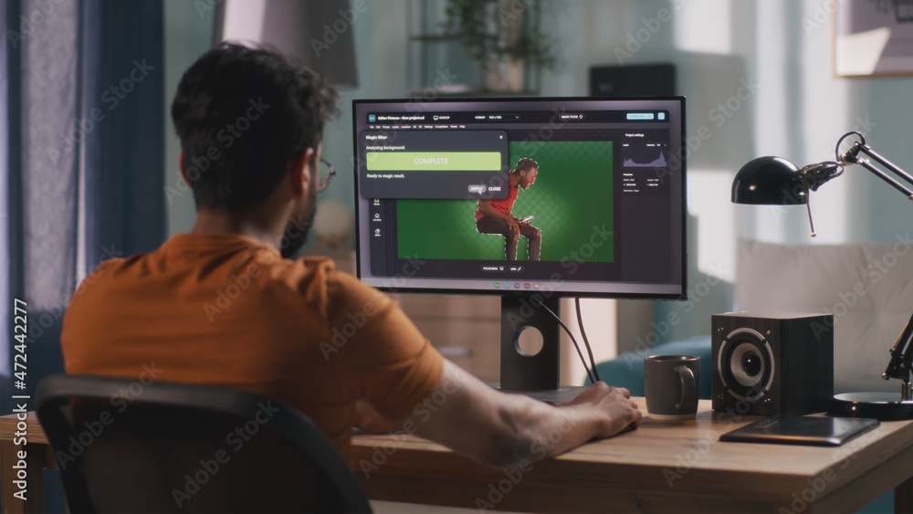 Poster anonymous male using computer to integrate 3d graphic into footage with real man during work in home