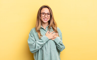 pretty caucasian woman feeling romantic, happy and in love, smiling cheerfully and holding hands...