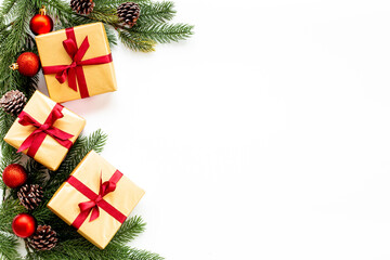 Fototapeta na wymiar Christmas golden gift boxes with red ribbon and xmas tree