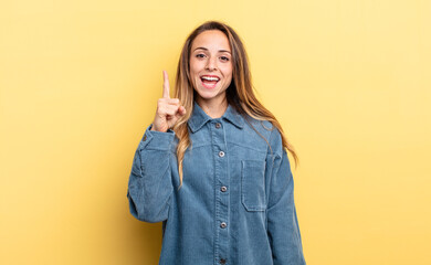 pretty caucasian woman feeling like a happy and excited genius after realizing an idea, cheerfully...