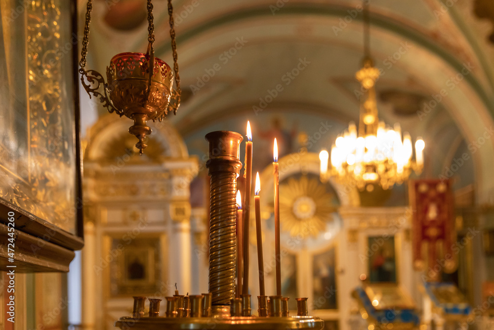 Wall mural Orthodox Church. Christianity. Festive interior decoration with burning candles and icon in traditional Orthodox Church on Easter Eve or Christmas. Religion faith pray symbol