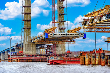 Construction of a new road bridge continues across the Sheksna river. Cable-stayed bridge. Fragment...