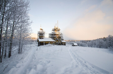 Church in the snowy forest. Abandoned temple 