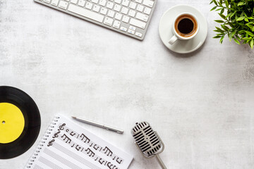 Music sheets with musical notes and microphone, top view
